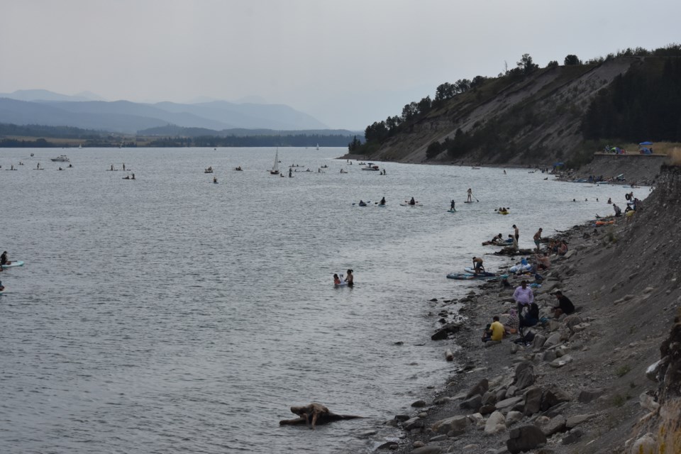 People swarm to the rocky shores of Ghost Reservoir Provincial Recreational Area to enjoy the long weekend heat on Saturday