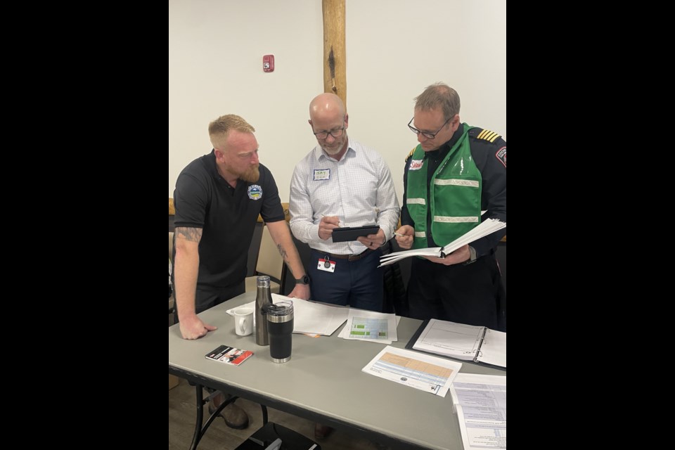 Andy Potton, Exercise Director for Search and Rescue Alberta / Jay Judin, Cochrane’s Director of Protective Services and Emergency Management, Shawn Polley, Cochrane Fire Chief.