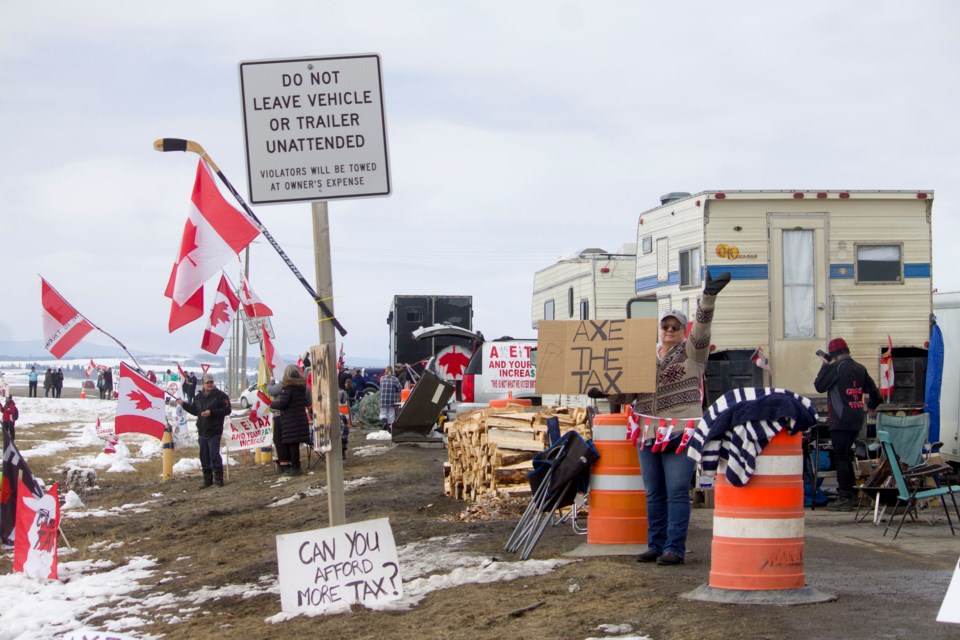 Carbon tax protests continue well into the weekend of April 6, as demonstrators can be found along both ends of the Trans-Canada Highway 10 minutes south of Cochrane.