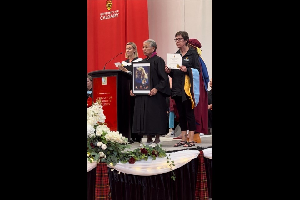 Tina Fox (middle) received son Trent’s posthumous PhD from the Universtity of Calgary on June 5.