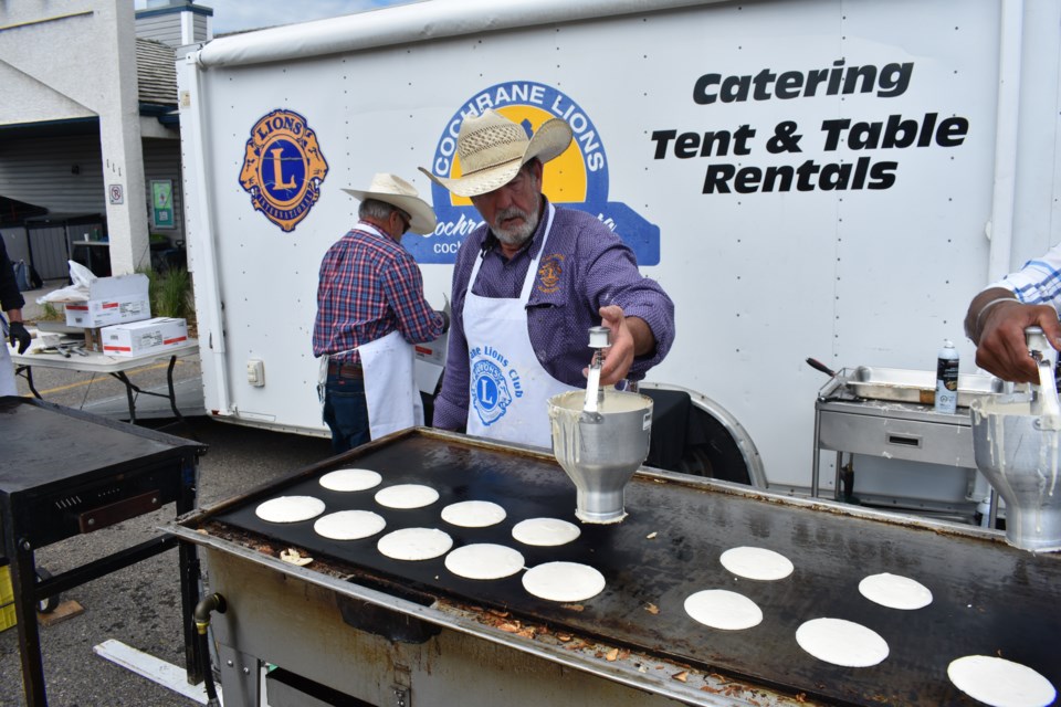 Gene Fox from the Cochrane Lions Club pours out pancakes at this mornings Stampede Breakfast at the Cochrane Lions Rodeo ground