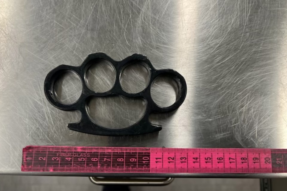  A search of the vehicle yielded a rifle, bear spray, brass knuckles, and illicit drugs.