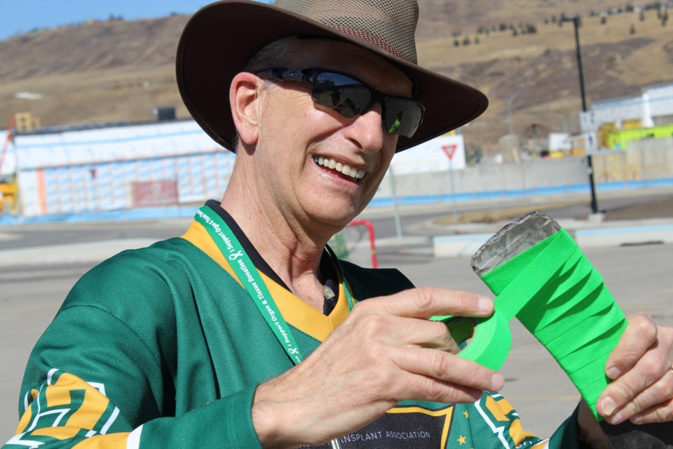 Cochrane organ donor recipient Greg Hnatuk helps out with taping up sticks on Green Shirt Day at the SLS Centre on April 6.