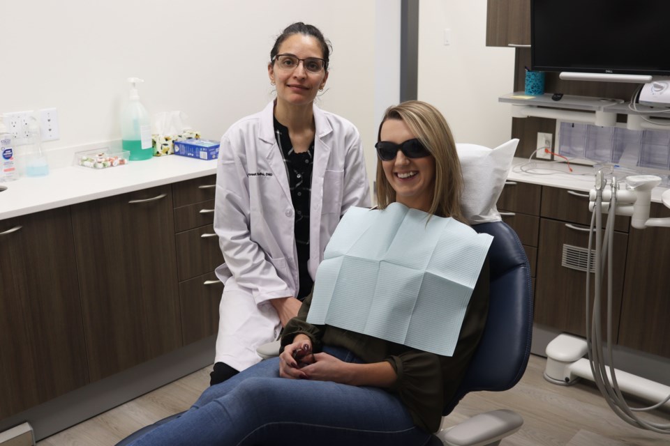 Dr. Gurpreet Sandhu of Mila Dental Clinic with patient. 