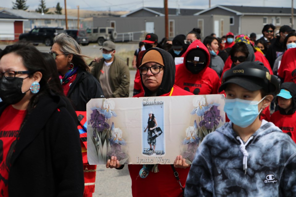 People hold up signs in remembrance of lost loved ones during a March for Missing and Murdered Indigenous Women, Girls and Two-Spirit (MMIWG2S) people in Morley May 11. (Jessica Lee/The Cochrane Eagle)