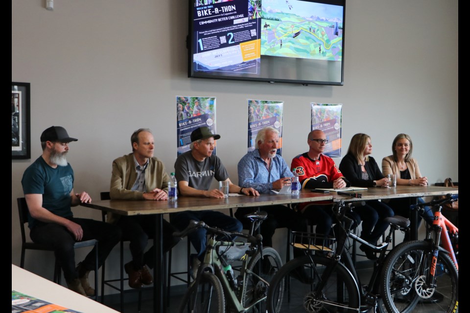 Sponsors and supporters of the Cochrane to Calgary trail project Shane Campbell, left, owner of Big Hill Cycle; Robert Martens, president of Bike Cochrane; Jim Rooney, managing director of Garmin Canada; Dan Kroffat, member of the Trail Steering Committee; Cochrane Mayor Jeff Genung; Sarah Parker, executive director of the Glenbow Ranch Park Foundation; and Ashley Fox, vice chair of Sport 4 Life Cochrane gather for a press conference at Garmin Headquarters May 13 to announce a Bike-A-Thon event beginning in June. (Jessica Lee/The Cochrane Eagle)