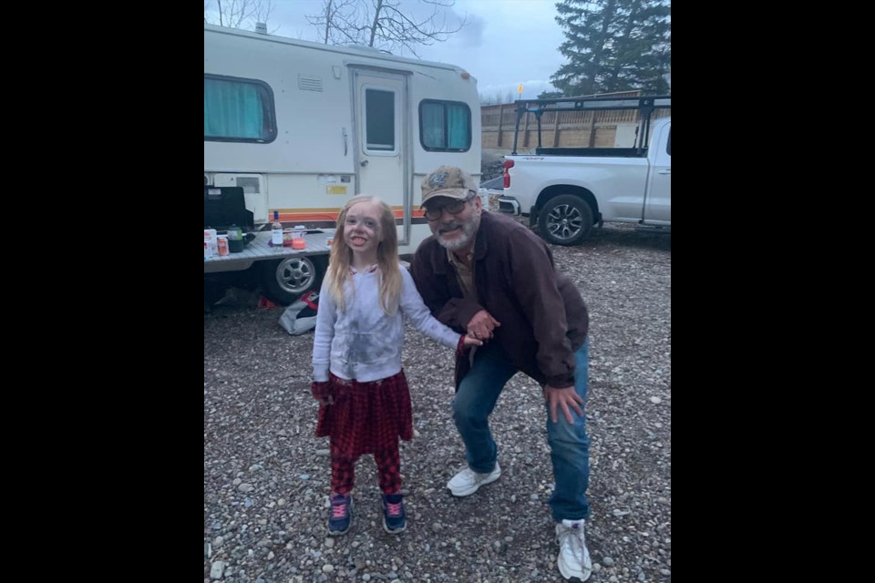 David Milgaard, right, stayed at the same campground as Crystal Blanchard, whose daughter is photographed with him here the day before he died. Milgaard gently walked the girl back to her parents when he discovered her painting herself with soot from an ash pile. Blanchard hopes to share the photo, along with the many memories they made with him while camping, with Milgaard's family. (Photo Submitted/Crystal Blanchard)