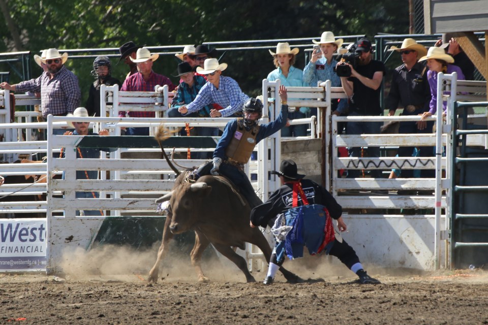 Cochrane's own Beau Gardner goes for a ride on the bull Blowing Smoke. (Tyler Klinkhammer/The Cochrane Eagle)