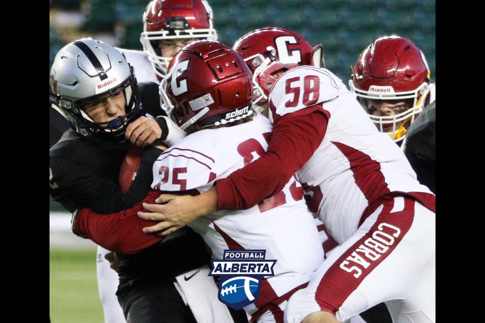 Cochrane Cobras linebacker Jackson Knox (#25), Jacob Patterson (#58) and teammates bring down Holy Rosary Raiders player Matthew Cavanagh in the ASAA Tier III provincial championship game at Commonwealth Stadium in Edmonton Nov. 26. The Cobras won 15-7 over the Raiders. (Photo Submitted/Football Alberta)