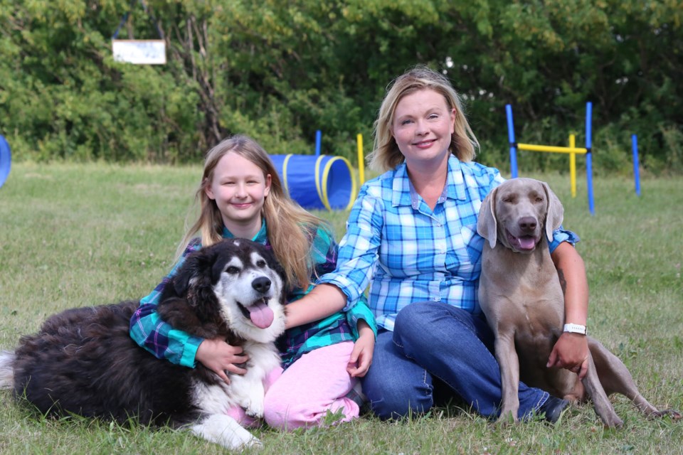 Sylwia Ciezar-Anderson (centre) started The Unleased Dog Park as a place for her dog Emma (right) to get some exercise. Photo by Tyler Klinkhammer/Great West Newspapers.
