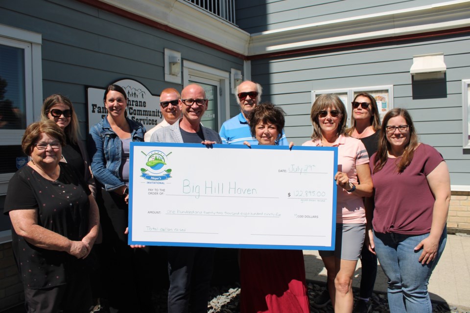 Mayor Jeff Genung and members of the volunteer committee for the Mayor's Invitational Golf Tournament were at the Cochrane FCSS offices on July 29 to hand off a cheque for $122,895 to Big Hill Haven. 
