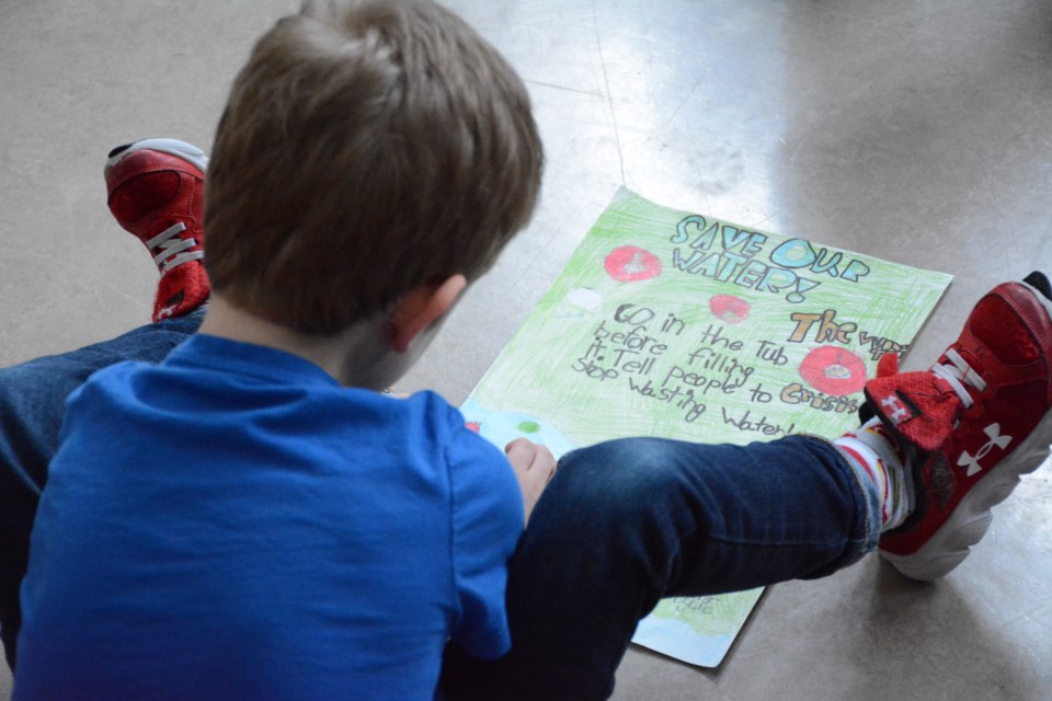 Grayson Moring working away on his poster. 