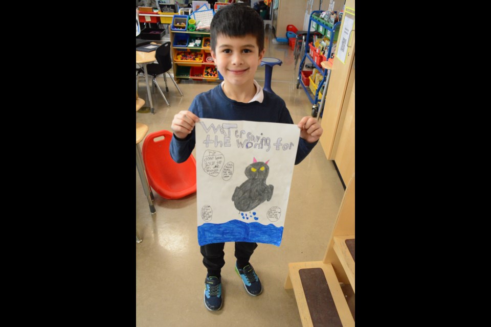 Adrian is all smiles with his water poster. 