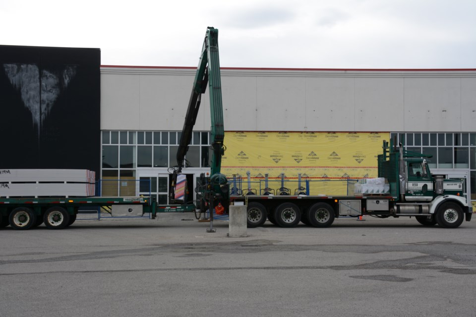 Construction crews are on scene at the old Canadian Tire building on Fifth Ave.