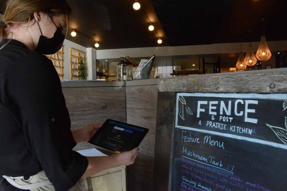 Staff member of Fence and Post, Riyan shows how the QR scanner works. 