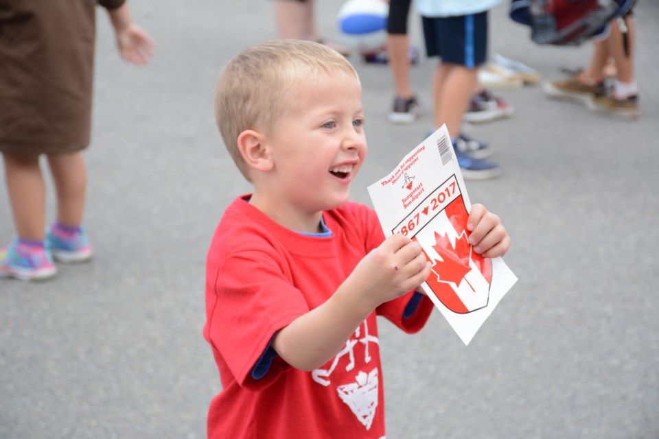 Arlo Haskett opens up his Jumpstart backpack to find stickers!