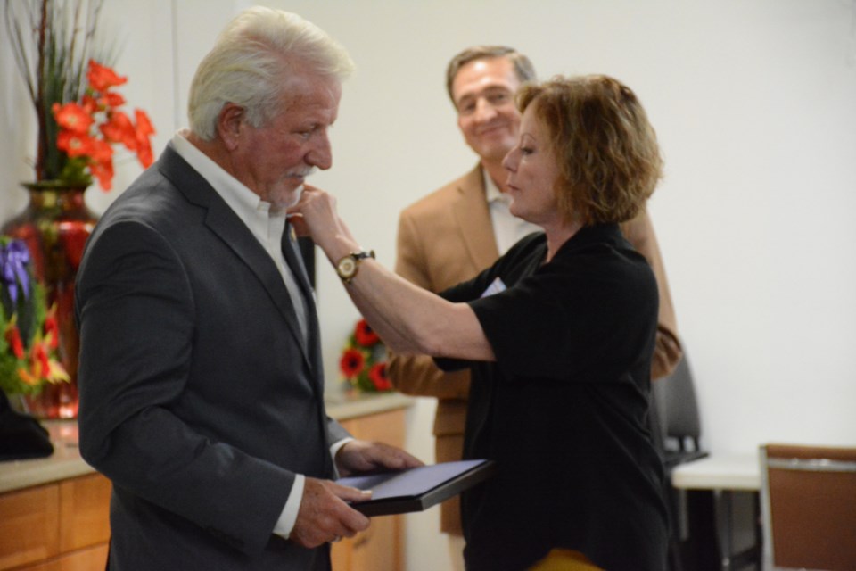 Dan Kroffat gets presented the Paul Harris Fellow by Christine Rendell.