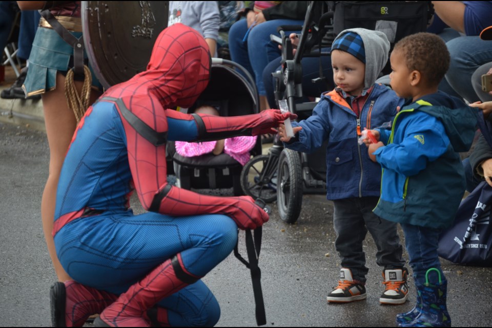 Spiderman meets with Mataio Marciniak, 2,  and Hendrix Mulli on the parade route. 