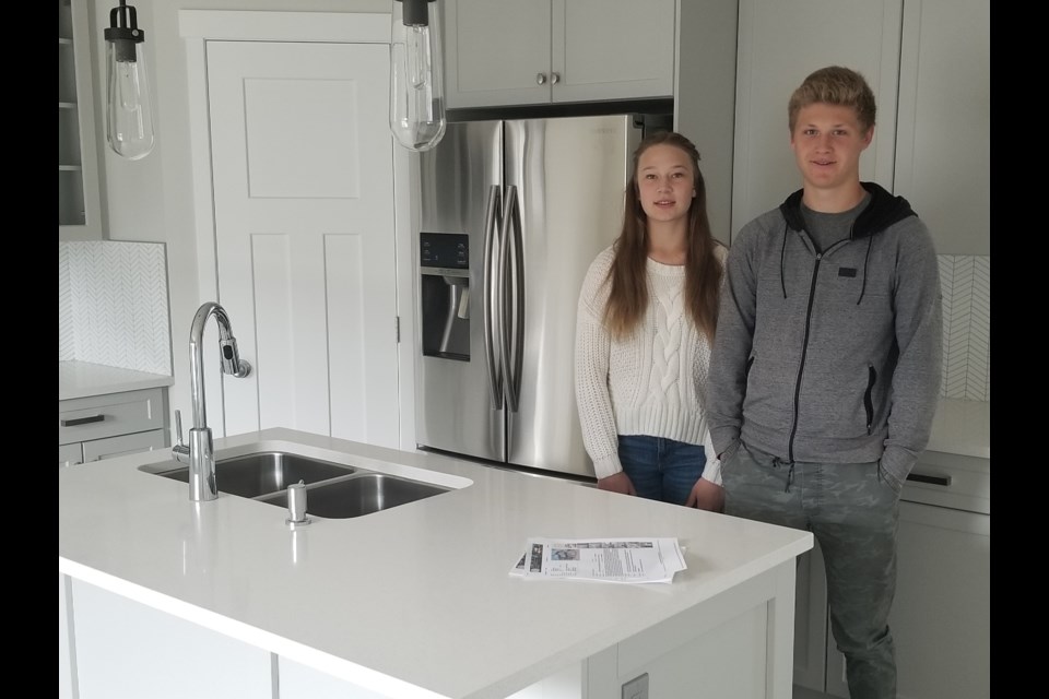 Building Futures students Jaeda Klassen and Treyton McClelland stand in the completed kitchen of 88 Willow Street.