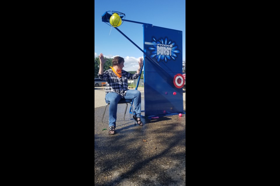 Coun. Tara McFadden waits for the balloon to drop during the Boys and Girls Club of Cochrane and Area's Stampede and customer appreciation breakfast. 