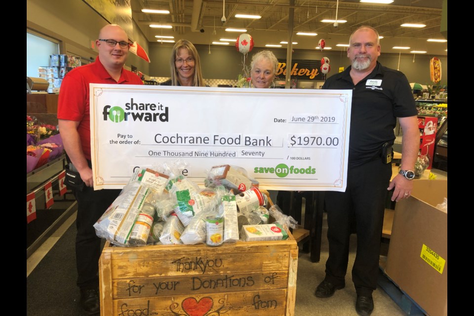 From Left to Right Billie  Hunt (Save On Foods) , Kathy Tucker (Cochrane Food Bank Coordinator), Elaine Stewart (Cochrane Food Bank Volunteer), Randy Carswell  (Save On Foods)