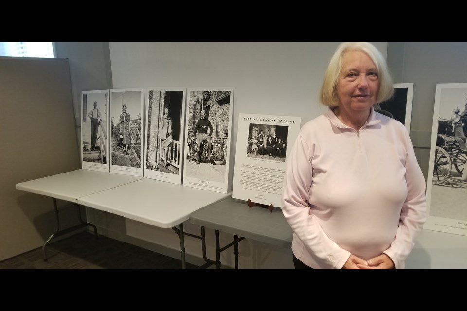 Wendy Vaughan stands with photographs of her ancestors, the Zuccolo family. She will be sharing the family's more than a century-long history in the area at the Cochrane Museum on Wednesday.