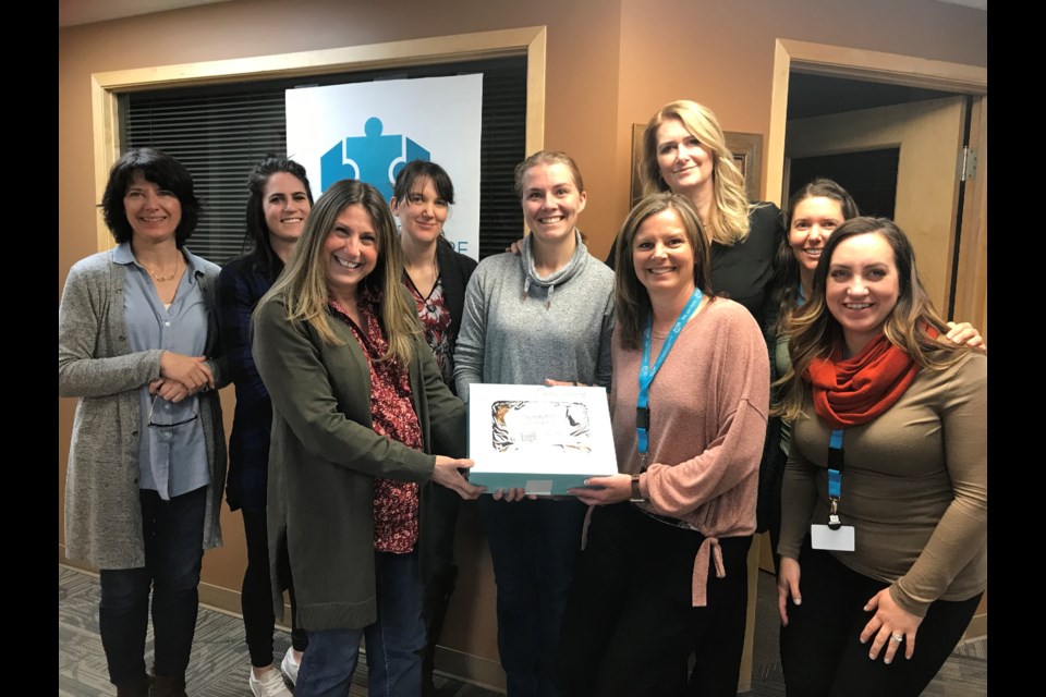 On Friday (Feb. 21) Cochrane Eagle advertising sales rep Kim Smith visited Cochrane Family and Community Support Services. Left to right, Kim Krawec manager of FCSS; Annemarie Tocher, resource centre coordinator; Kim Smith; Cydney Korner, youth support worker; Natalie Brulotte, community support worker; Nicole Copses, administrative assistant; Tracy Tilma, administrative assistant; Kristen Immel, community programmer; Hillary Cornelius-Stormon, older adult programmer. Submitted photo