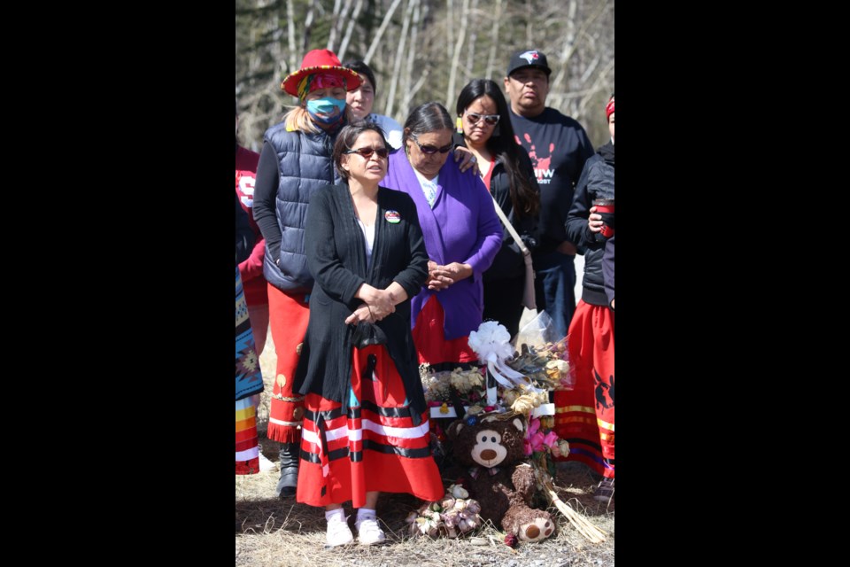 Heather Poucette, the mother of Keesha Crawler, stands with the family and friends of her late daughter. The women in attendance wore red dresses, which has become a symbol to honor and commemorate missing and murdered Indigenous women. (Tyler Klinkhammer/The Cochrane Eagle)