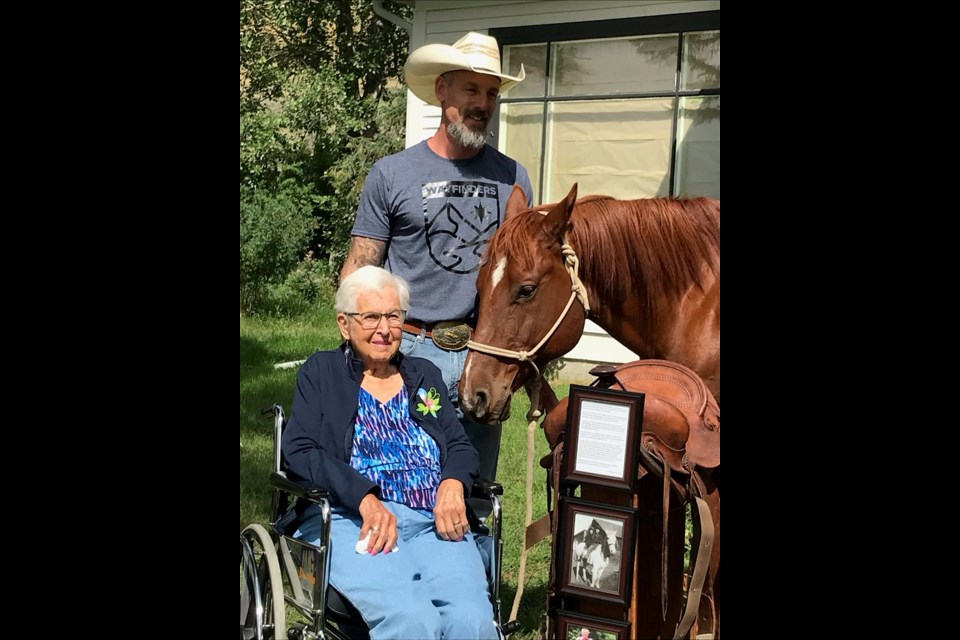 Paul Wagman and Kathleen Beynon pose for a photo with Spud the equine therapy horse, and Beynon's donation. Photo submitted.