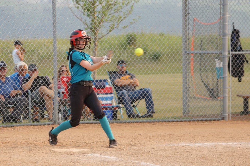 Kaylynn Hovde connects on a big swing to send the ball clear into the outfield. (Tyler Klinkhammer/The Cochrane Eagle)