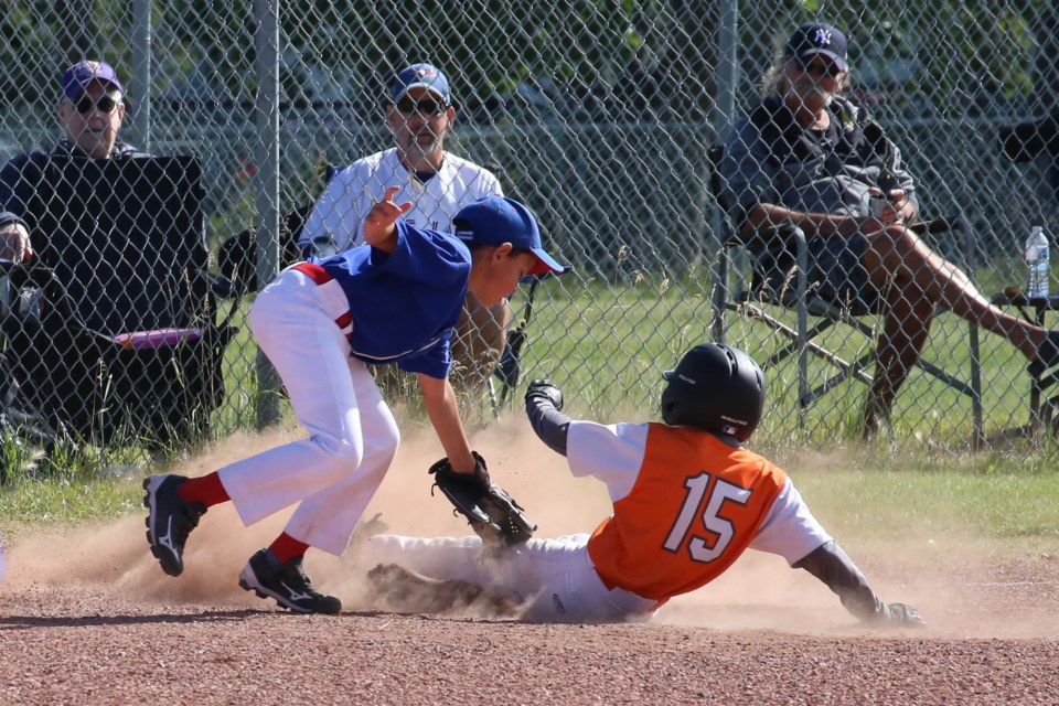 Ty Krooshoop connected on a hit and rounded the bases, sliding safely into third base. He would make it home on the next hit when his teammate, Braeden Bohach-Murray sent another ball into the outfield. (Tyler Klinkhamer/The Cochrane Eagle)