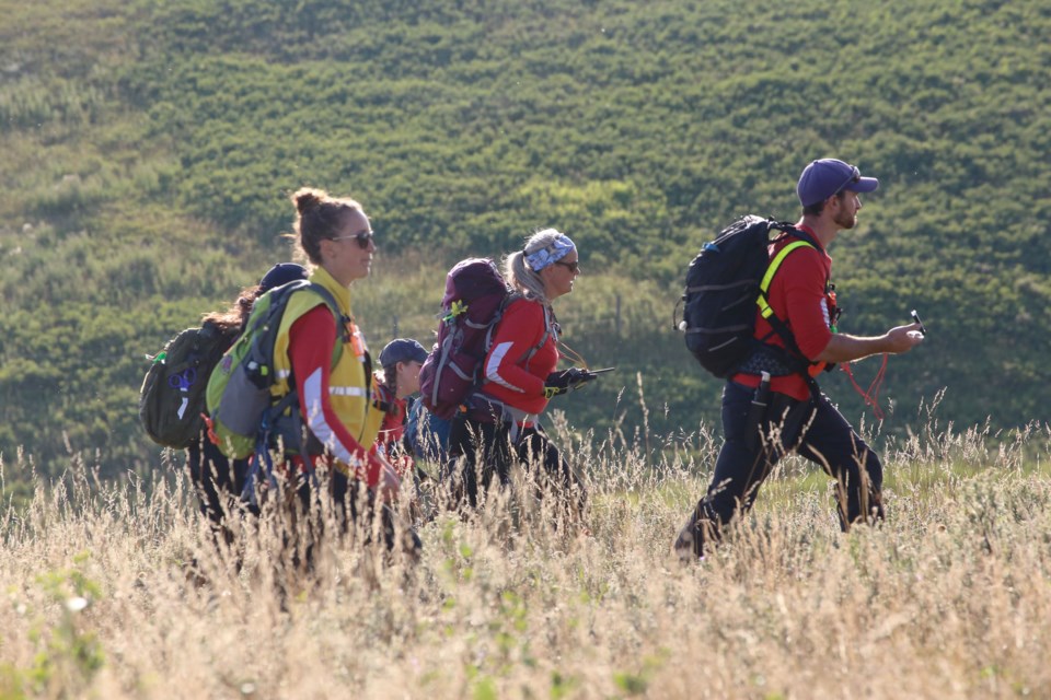 Members of Cochrane Search and Rescue comb the landscape for clues of a missing person during a training exercise on Aug. 13. (Tyler Klinkhammer/The Cochrane Eagle)