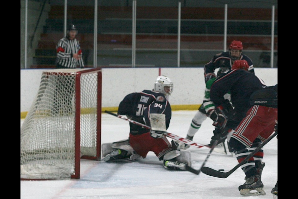 Goalie Jordan McGinnis stops a shot, helping to seal the shutout for the Cochrane Generals Sunday.