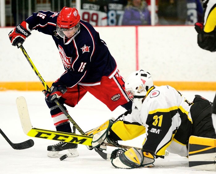 Cochrane Generals forward Matt Kaczur works in front of Strathmore Wheatland Kings goalie Liam Banks in Heritage League play Jan. 4 at Spray Lake Sawmills Family Sports