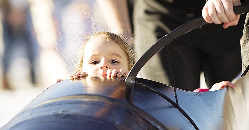 Lily Boylan enjoys the view from a bobsleigh, as Alberta bobsleigh team members Aiden Simpson and Ben Kernan push her down a makeshift track at last year&#8217;s Cochrane