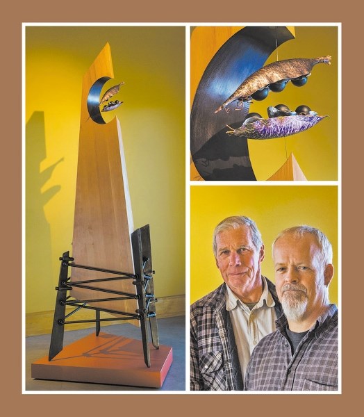 “;Spirit Rising,”a 2.5m (8 ft.) tall magnet-topped obelisk of Douglas fir by Cochrane artists Mike Simpson (left) and Glenn Lott, ascends from an iron cage to symbolize “;the 