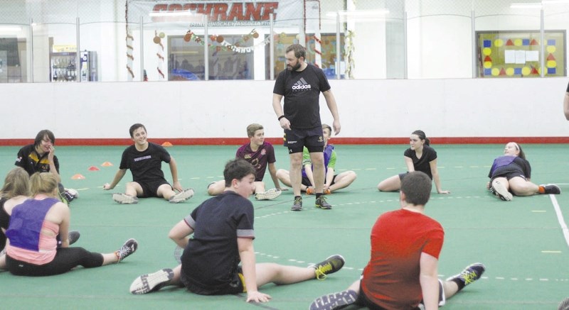 Bow Valley Grizzlies men&#8217;s player and under-19-year-old (U19) coach Scott Megraw has his players stretch following a robust rugby skills workout Jan. 9 on Spray Lake