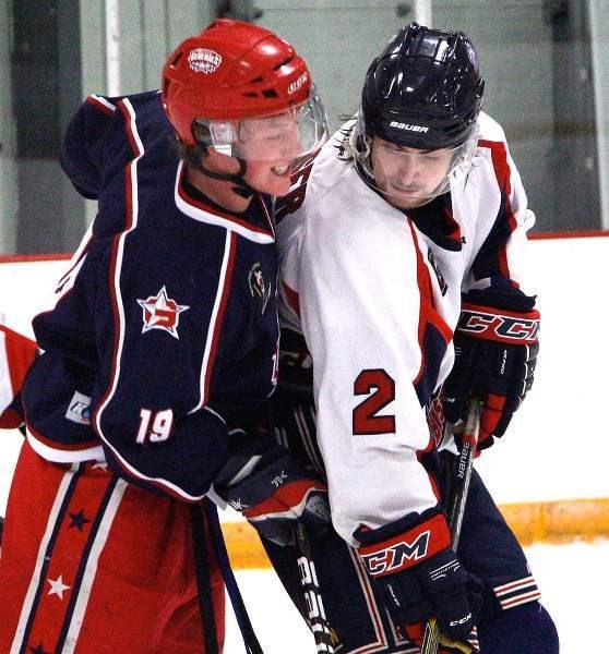 Cochrane Generals forward Talus Hume and Okotoks Bisons defenceman Aiden Geiger battle for the puck in Heritage League play Jan. 16 in Cochrane. Gens won 3-2.