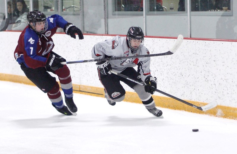 Airdrie-Cochrane (AC) Avalanche defenceman Trey Wallace chases Rockyview Raiders forward Dylan Prpich in Alberta Minor Midget AAA Hockey League play Jan. 24 in Cochrane. The