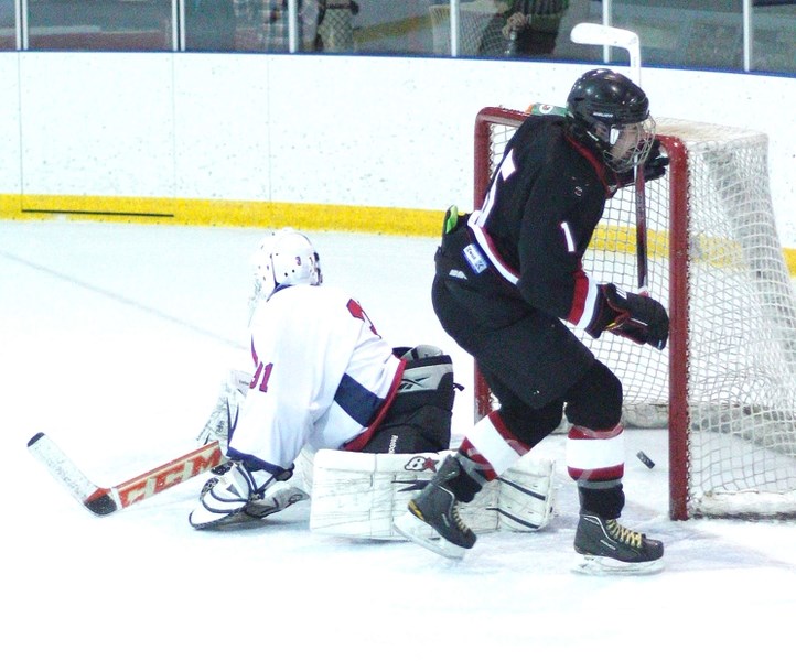Bow Valley Timberwolves forward Tyler Wood scores the tying goal against Lethbridge Hurricanes goalie Andrew Suriano in South Central Alberta Midget AA Hockey League play