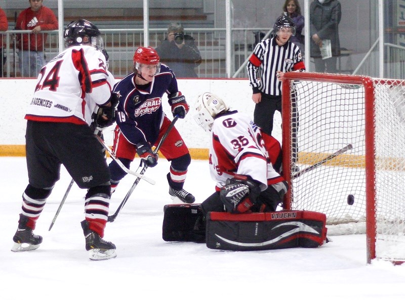 Cochrane Generals forward Talus Hume feeds the puck past Ponoka Stampeders goalie Zane Steeves for the overtime winner in Heritage Junior Hockey League play Jan. 24 in