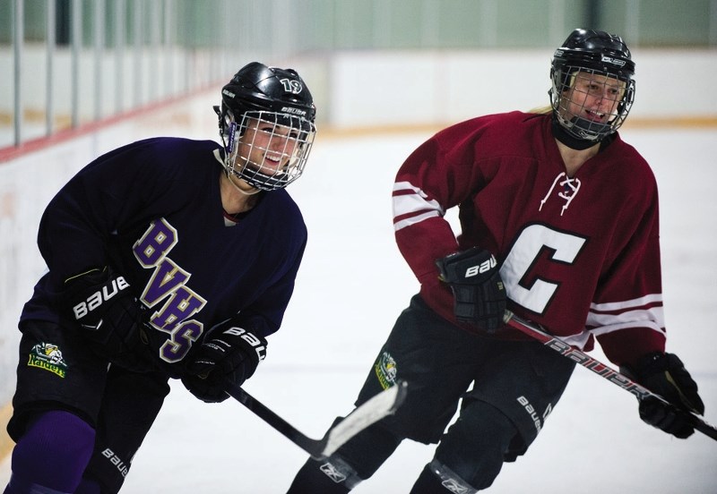 Hannah Olenyk, left, of Bow Valley High School and Kara Kondrat from Cochrane High School play in last year&#8217;s Cochrane Classic hockey game. Students from the high