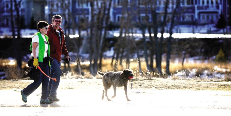 Jim Uffelmann, his partner Patti McDonald and his dog Lulu take a walk at the off-leash park near Spray Lake Sawmills Family Sports Centre Jan. 25.