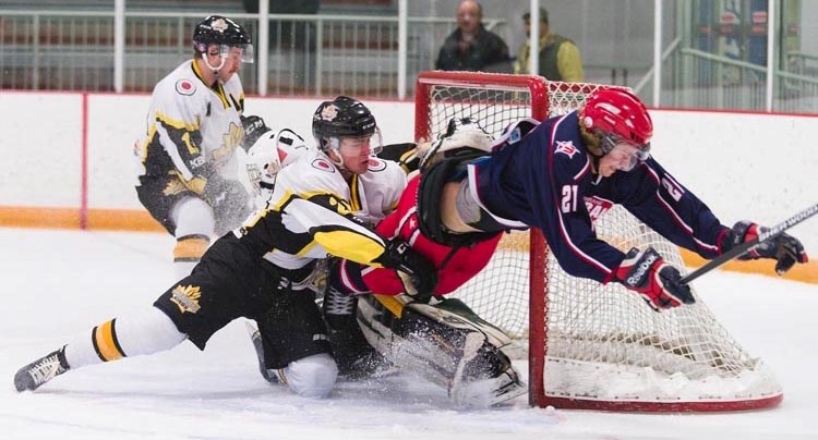 Cochrane Generals forward Slater Ransom dives through the Strathmore Wheatland Kings goal crease after being shoved by Strathmore&#8217;s Andrew McCann in Heritage Junior