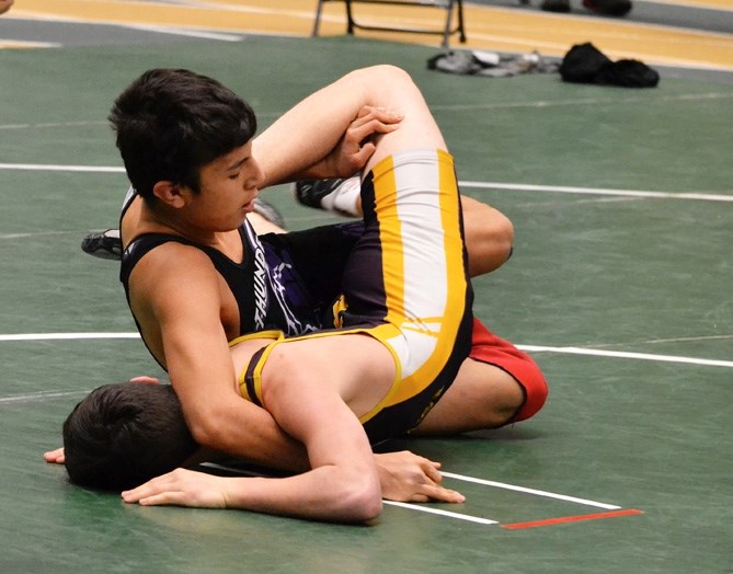 Cochrane Cowboys wrestler Charles Cook goes to work at University of Alberta Golden Bear senior high school wrestling tournament in Edmonton on Jan. 30. Cook won silver at