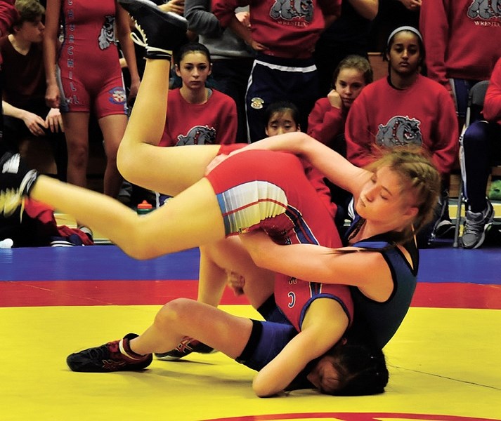 Brooklyn Thomson (right) at the Golden Bear High School Invitational in Edmonton. The female wrestler came away from the meet with a bronze medal.