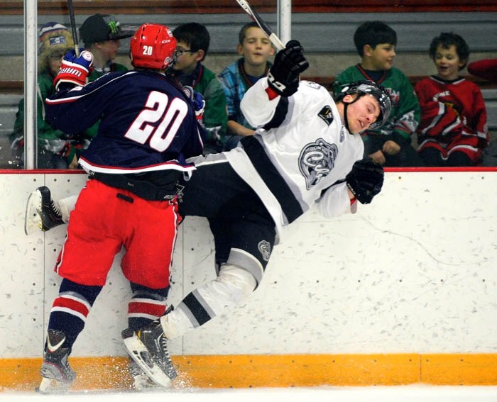 Generals forward Colby Chartier drills Medicine Hat Cubs forward Donoven Quenton along the boards in the final Heritage Junior Hockey League regular-season game for both