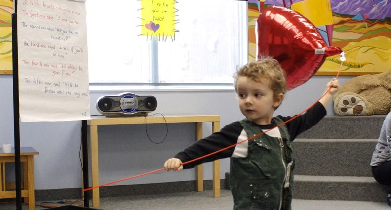 Two-year-old Ryerson Coleman finally gets a hold of his Valentine&#8217;s Day balloon at the Valentine&#8217;s Day event and open house held at the Nan Boothby Library Feb.