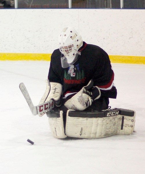 Bow Valley Timberwolves netminder Devin Daviduk eats up a puck in South Central Alberta Midget AA Hockey League play against visiting Okotoks Oilers on Feb. 15 at Cochrane