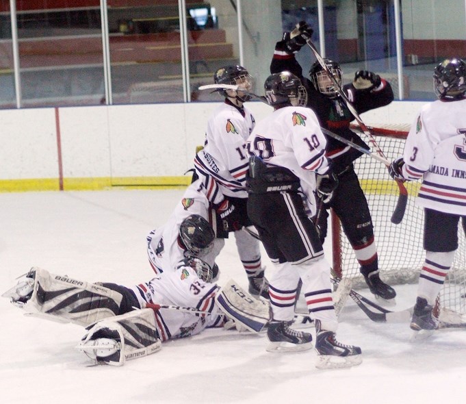 Bow Valley Timberwolves forward Keenan McElroy celebrates his overtime winner against visiting Red Deer Ramada in South Central Alberta Bantam AA Hockey League opening-round